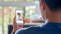 Male patient talks with doctor during a telehealth visit.